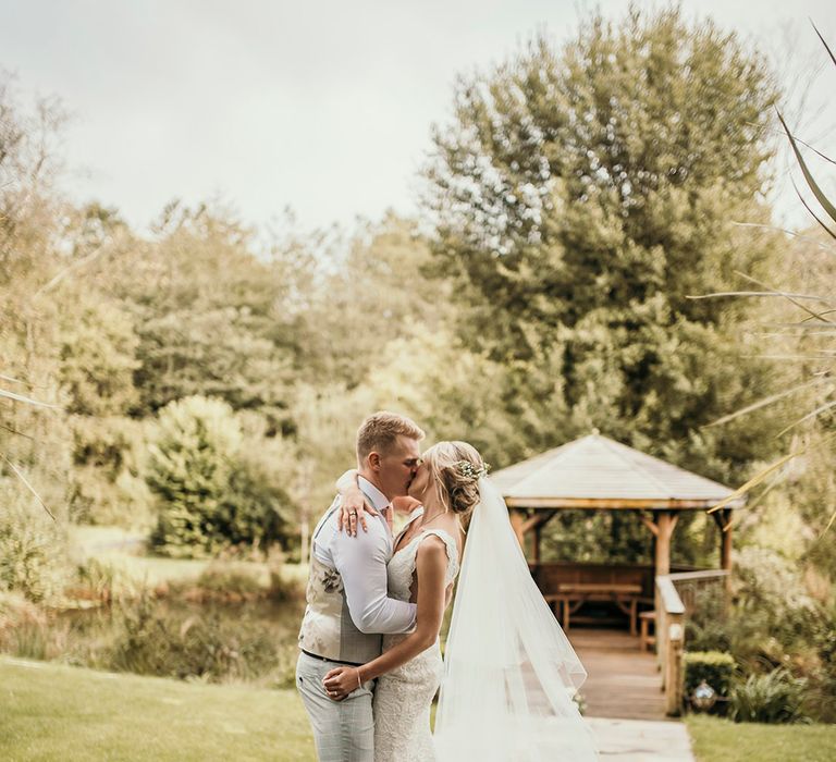 Bride and groom share a kiss in the gardens of Chycara venue