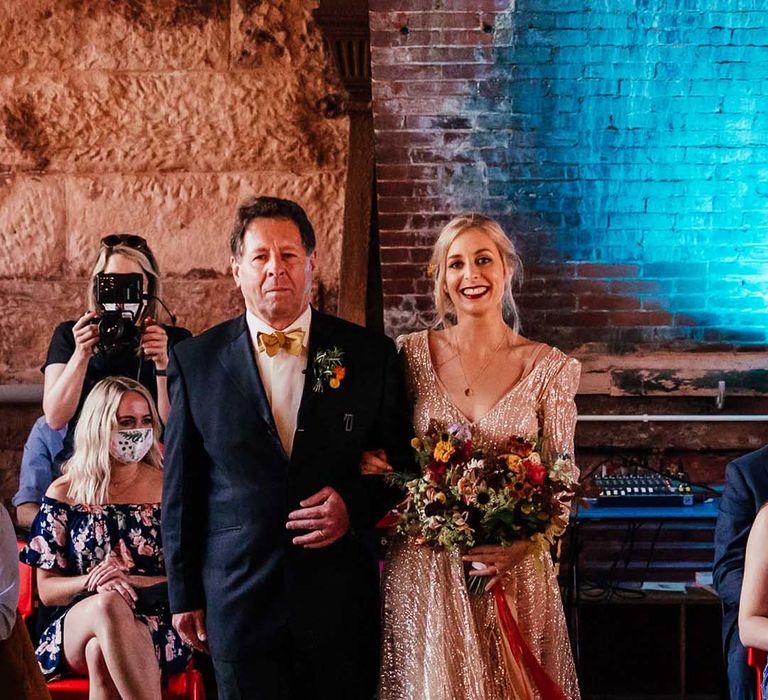 Bride walks down the aisle with her father