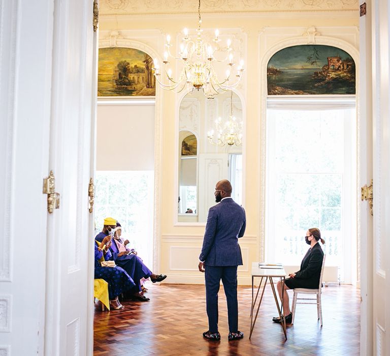 Groom wears blue suit on his wedding day