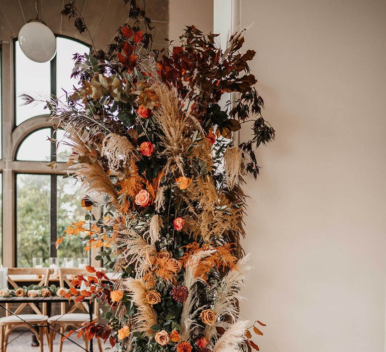 dried and fresh flower column wedding floral arrangement with silver disco balls 