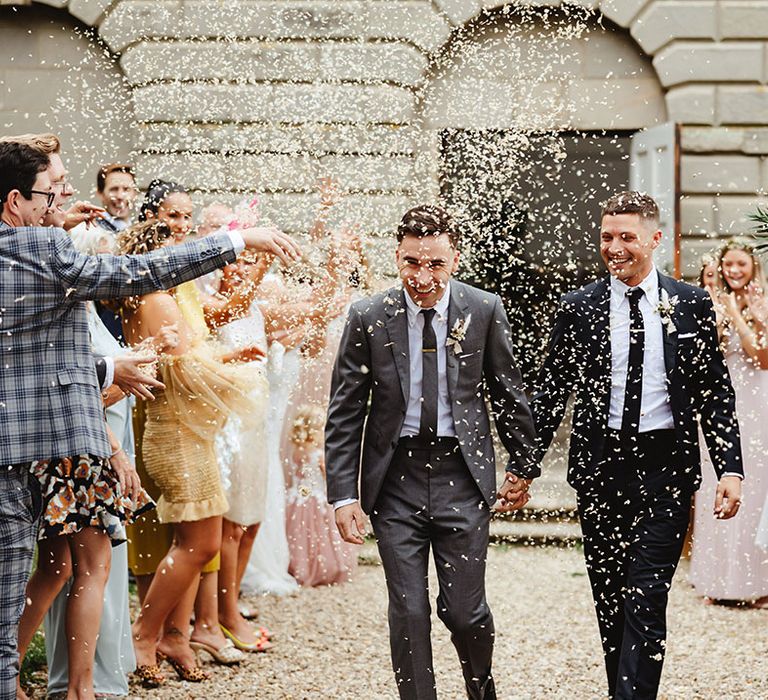 Grooms in black and grey suits have their confetti exit at Compton Verney Gallery and Park