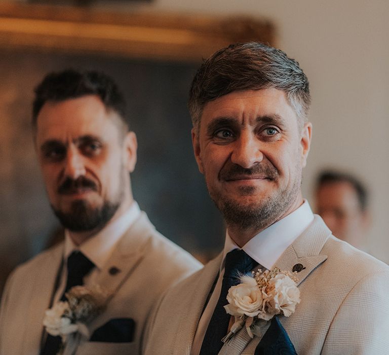 Groom smiles with love in his eyes as he sees the bride for the first time 