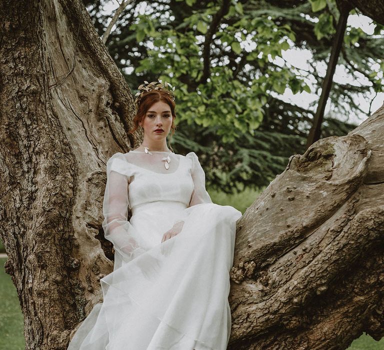 Eco bride in a sustainable fabric wedding dress with two layers and gold leaf jewellery 