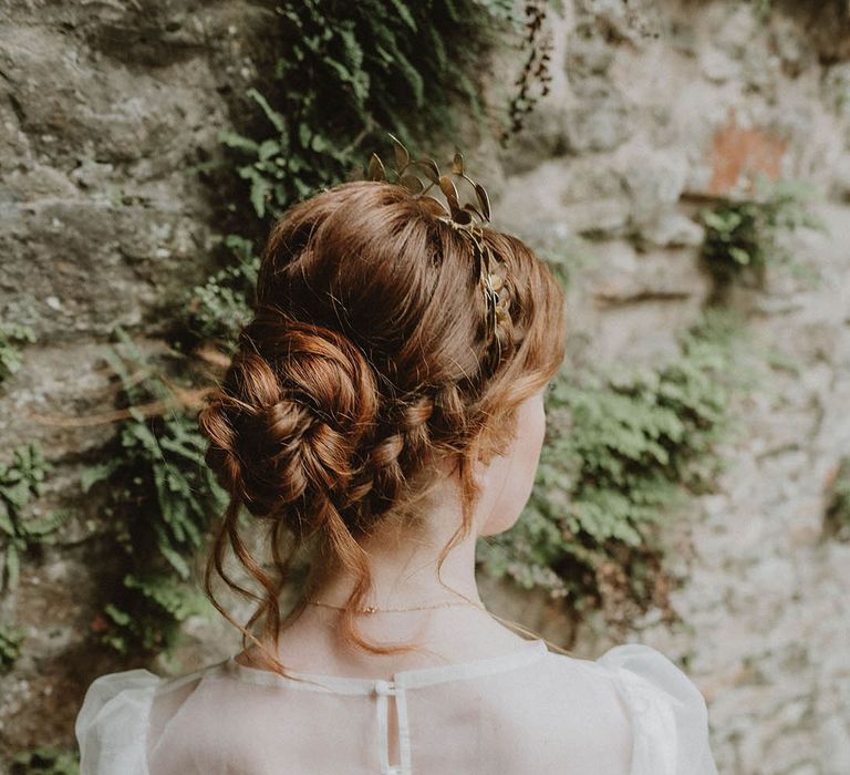 Bride with wearing a wedding dress with sheer top layer with buttons and long sleeve with a chic wedding hairstyle 