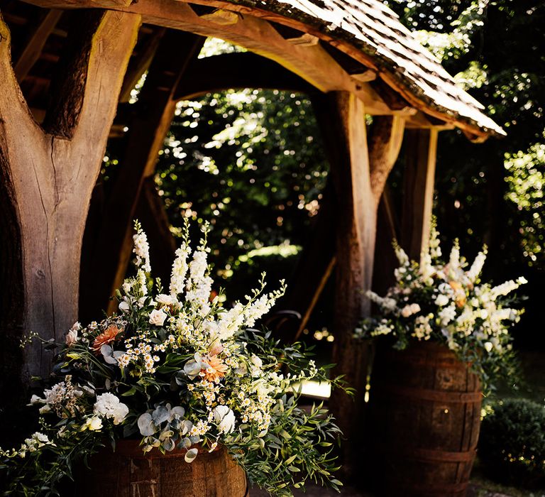 Cripps Barn outdoor wedding ceremony area with wedding flower decor 