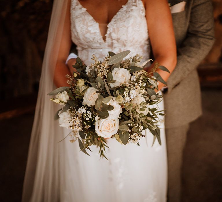 Classic white roses and flowers with greenery for the bridal bouquet 