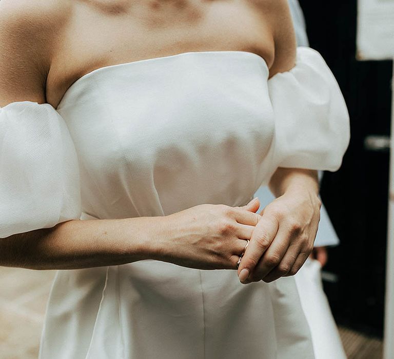 Bride wears Jesus Peiro wedding dress complete with detachable puffed sleeves 