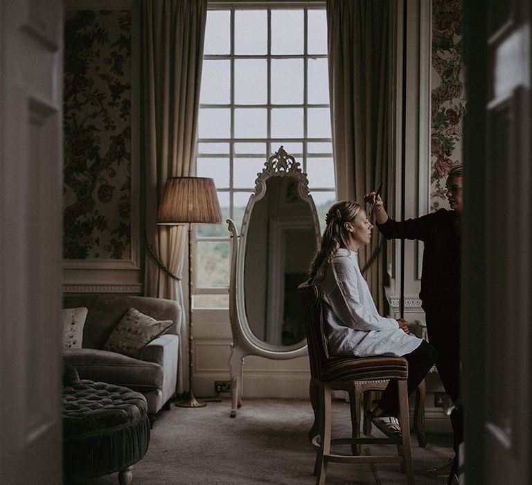 Bridesmaid has her makeup done at Hedsor House 