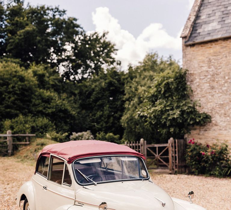 The bride's Mini convertible wedding car in a cream colour 