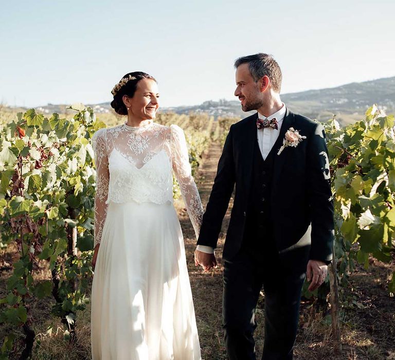 bride in a lace wedding dress and groom in a black suit at boho wedding in Portugal 