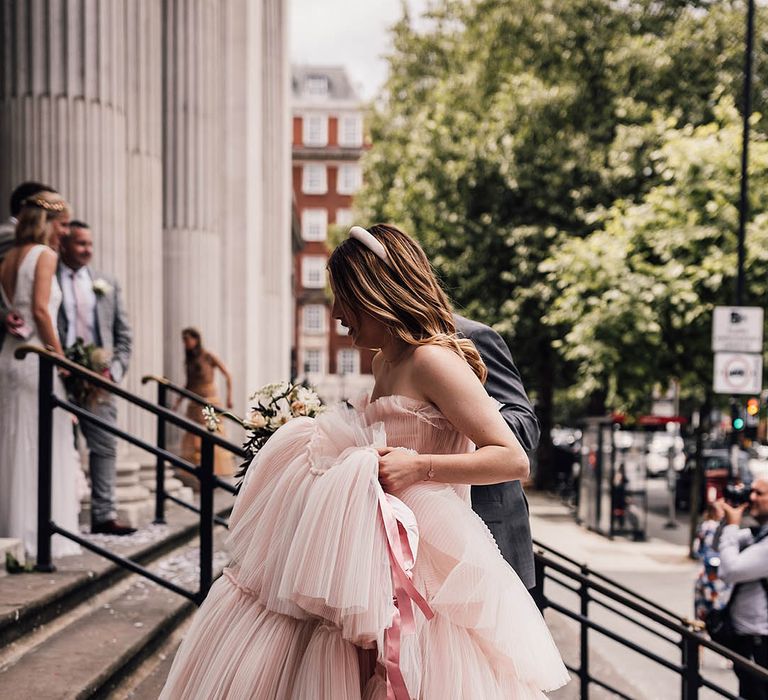 Bride in layered ruffle baby pink strapless wedding dress made bespoke for the bride at town hall wedding 