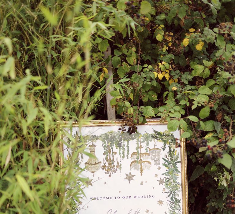 Wedding welcome sign in gold frame with stars and chandelier design 