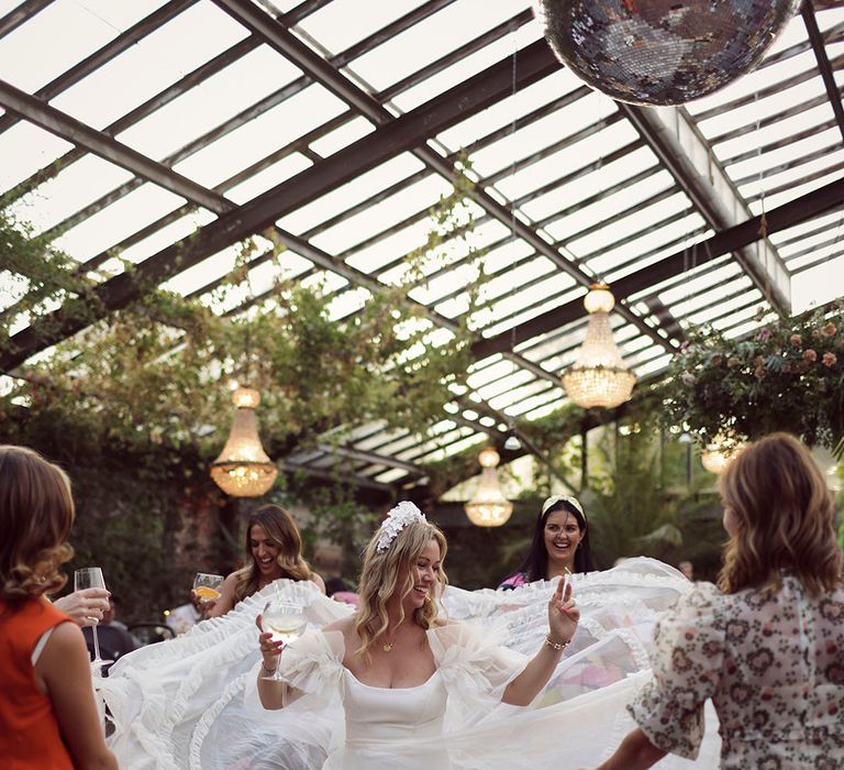 Bride in stunning ruffle wedding gown by Halfpenny London dancing at Anran wedding venue in Devon 