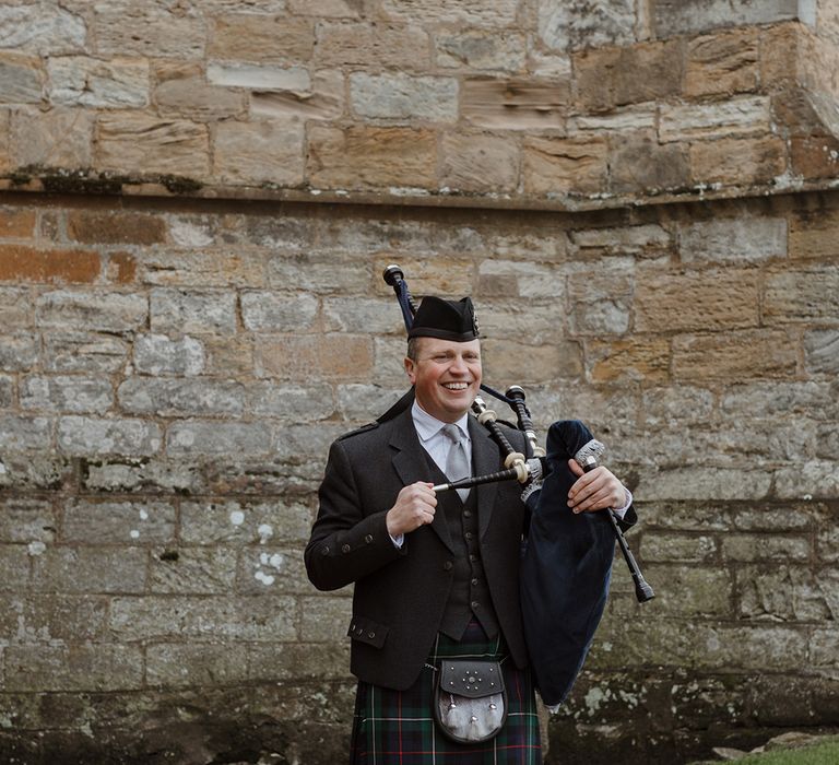 Bagpipe wedding entertainment playing as guests walk into ceremony 