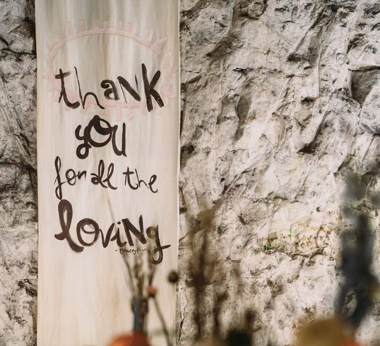 Alternative off-white wedding banner with "Thank you for all the loving" written on it at Margate Caves