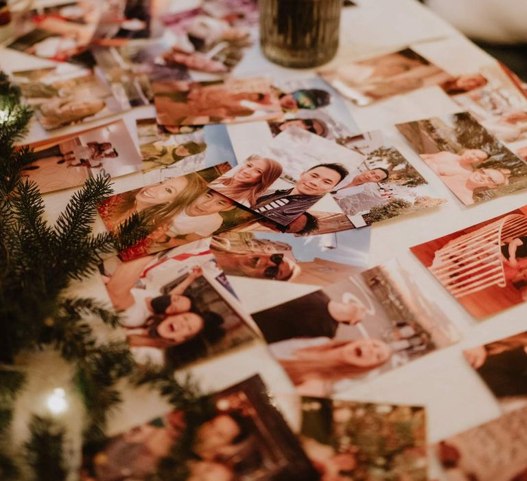 DIY wedding decor - print out photographs on wedding table with flower arrangement at ski wedding