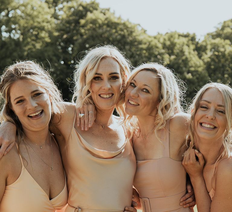 Bridesmaids in mismatched style neutral bridesmaid dresses for the wedding party 