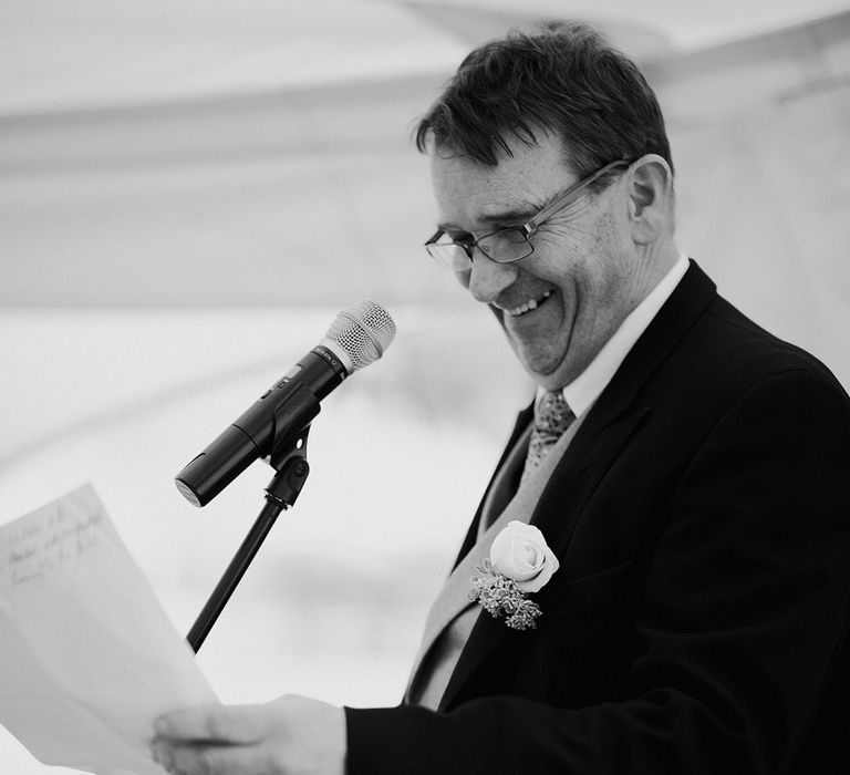 Father of the bride reading out wedding speech 