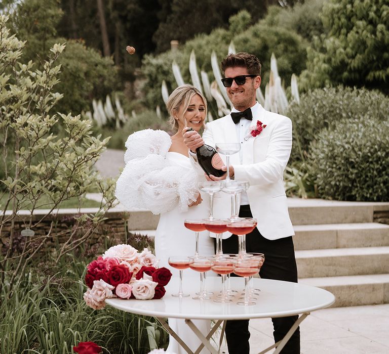 Champagne tower wedding decor with bride and groom at classic wedding 