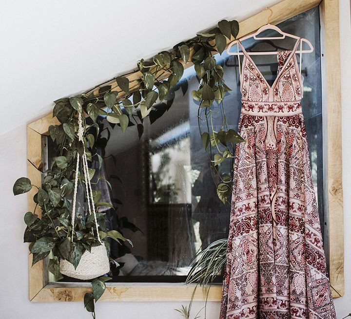 Pink Rue de Seine boho wedding dress hanging on a wall