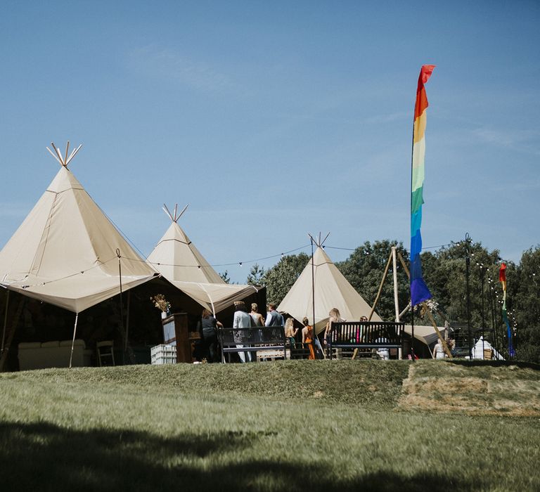 Tipi wedding venue in bride's family home with rainbow coloured flag