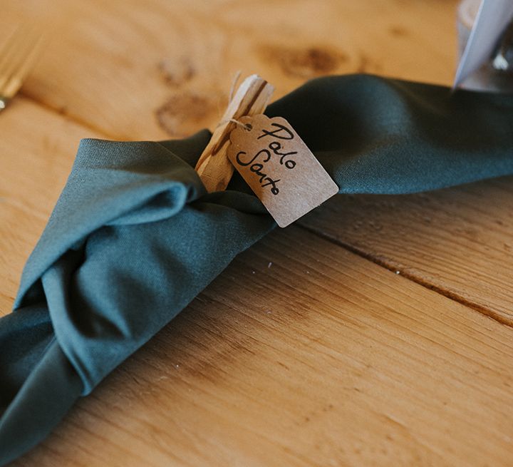 Dark green wedding table napkins with brown paper name tags