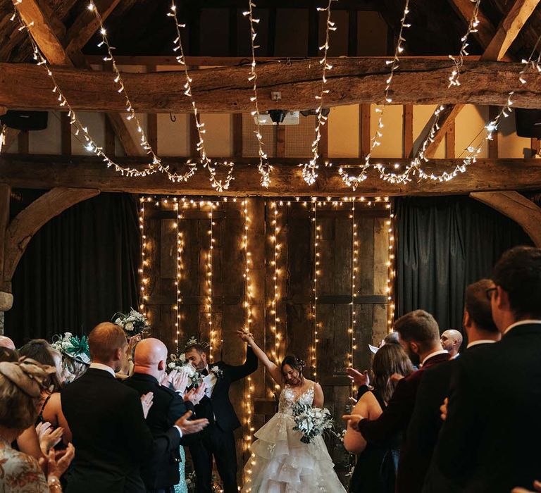 The Tythe Barn Launton wedding ceremony with string lights