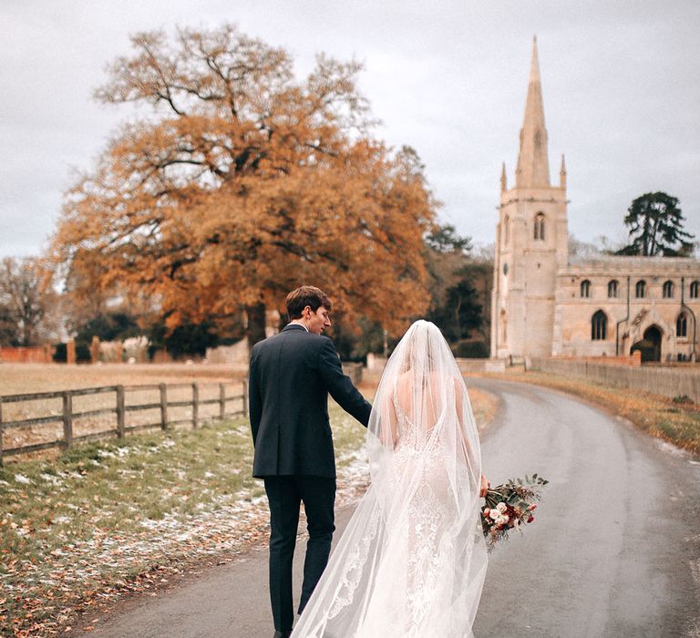 Festive winter Christmas wedding with the bride wearing a lace veil and wedding dress 