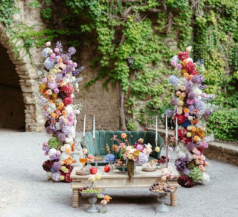 Colourful wedding flower columns with pastel and bright tones with dahlias and hydrangeas 