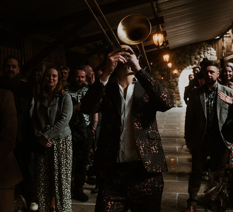 Trumpet player walks down the aisle as part of live brass band 