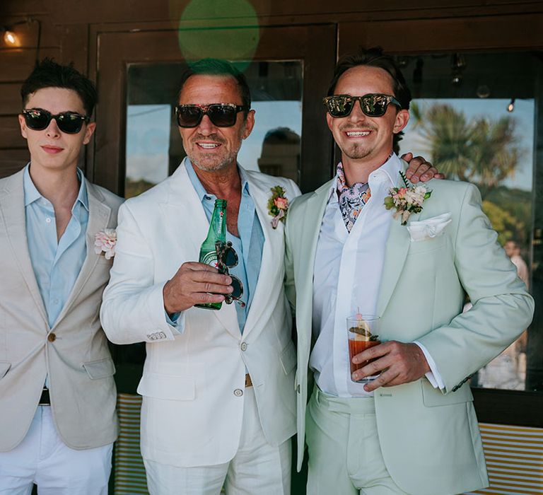 Groom and groomsmen posing together on the morning the wedding 