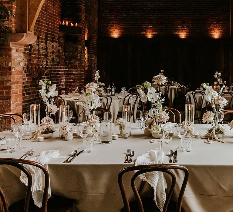 Classic all white wedding tablescape with white wedding flower arrangements 