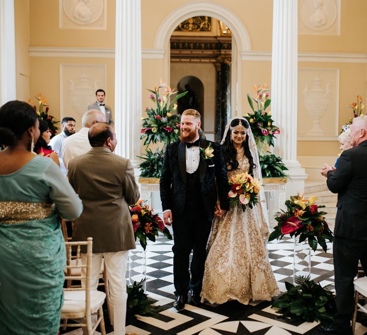 Bride and groom descending the aisle as husband and wife