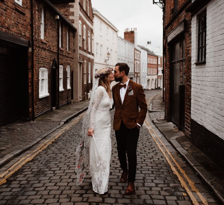 Bride and groom walking through Chester Town 