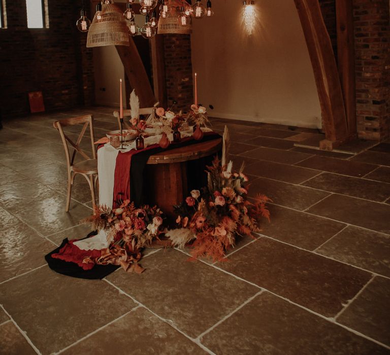 Sweetheart table with orange and neutral wedding flowers 