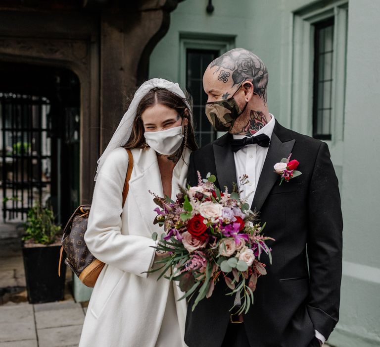 Bride and groom in face masks at 2020 wedding 