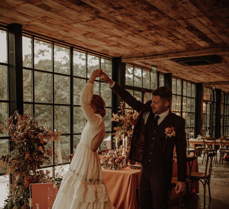 Backless wedding dress with long sleeves and tiered skirt 