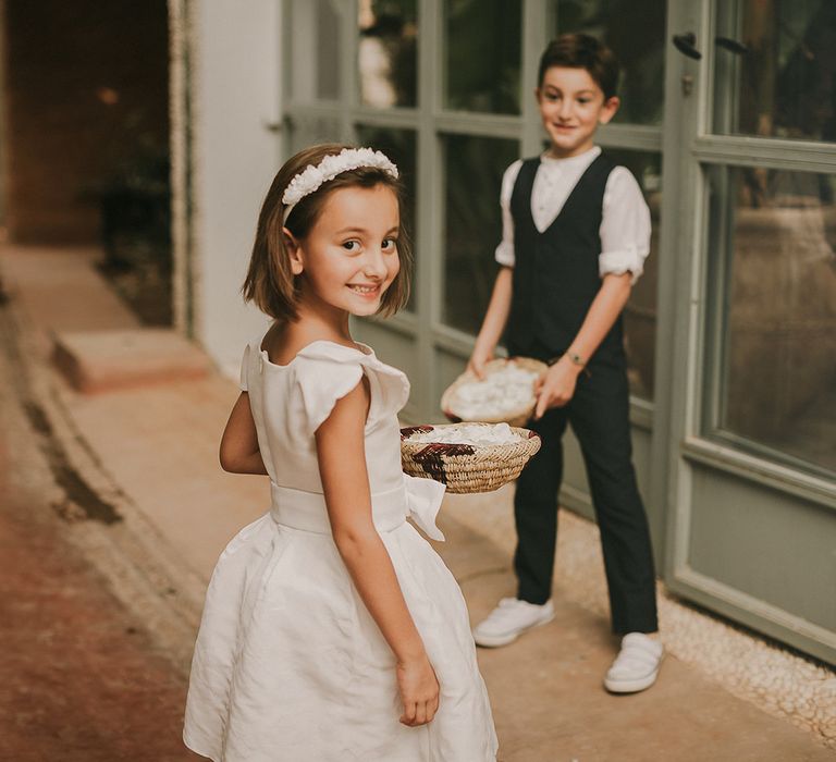 Flower girls and page boys with petal baskets 