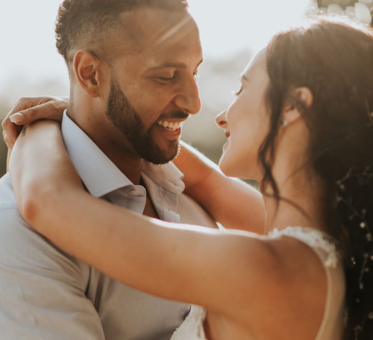 Bride and groom close up of them smiling near sunset