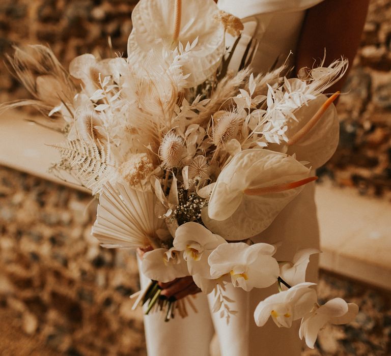 Neutral dried flowers wedding bouquet with orchids, anthuriums and roses