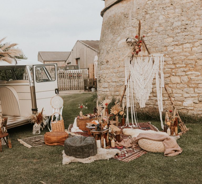 Outdoor picnic in boho inspiration with camper van and grazing plate