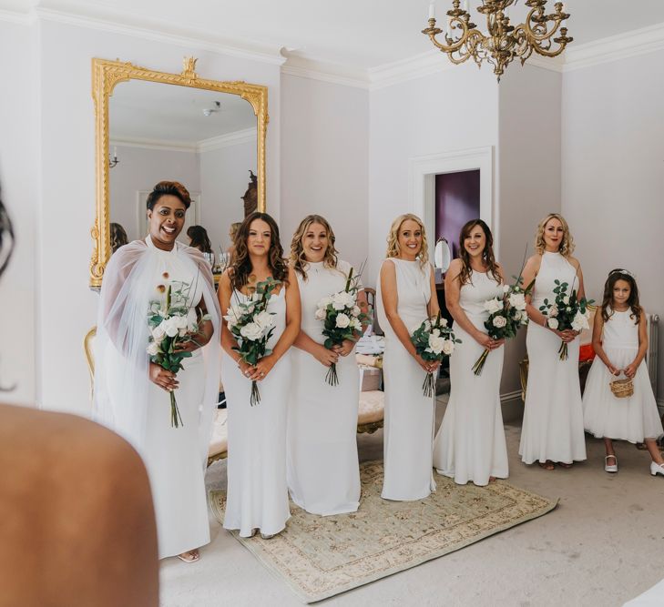 Bridal party in different White high street bridesmaid dresses 