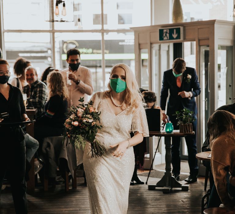 Bride walks into pub wearing bridal face mask 