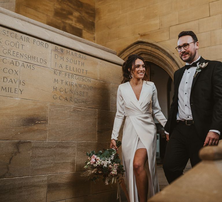 Bride & groom walk down the stairs at Sherborne School