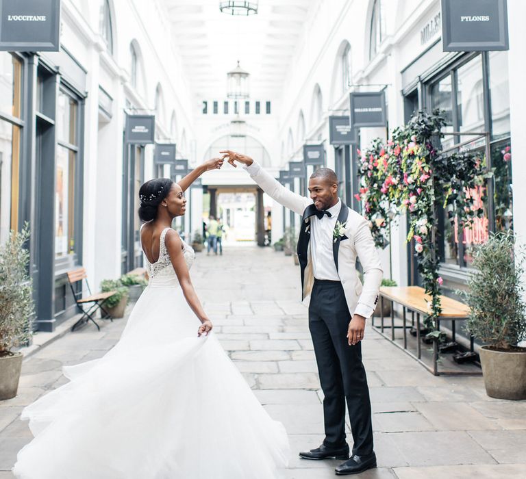 Grooms twirls bride around in London