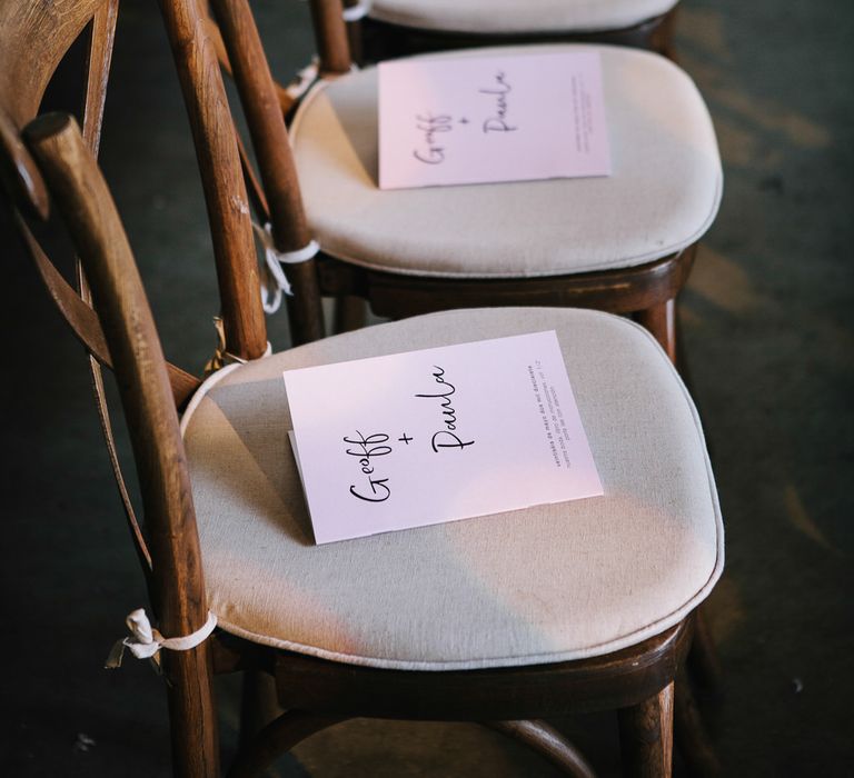 Minimal order of service booklets place on chairs by My Beautiful Bride