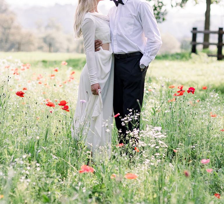 Romantic bride and groom portraits in a poppy meadow at country house wedding venue 