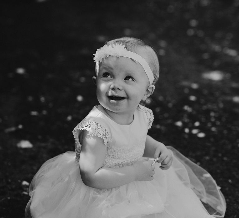 Flower girl sits in the grass for black & white image