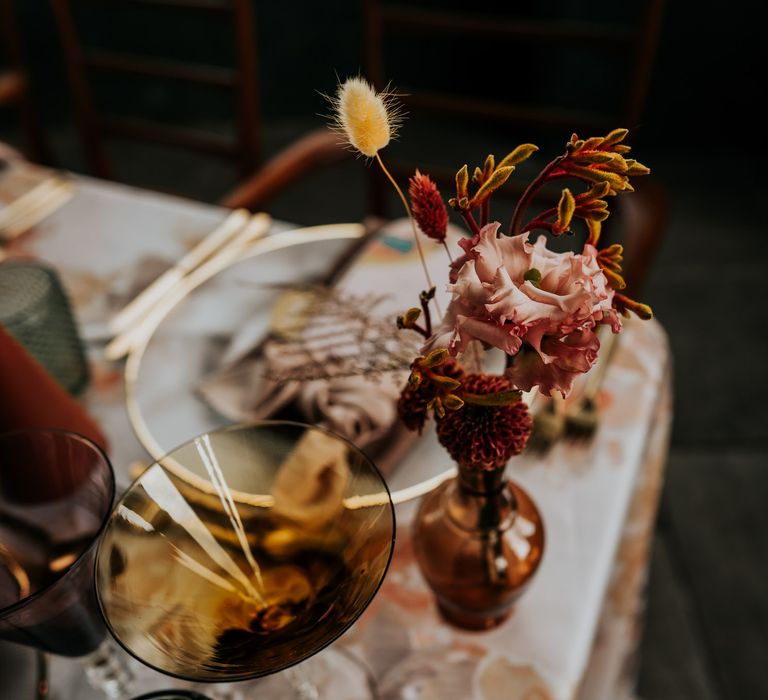 70s wedding table decor with brown vases and vessels filled with autumn flowers 