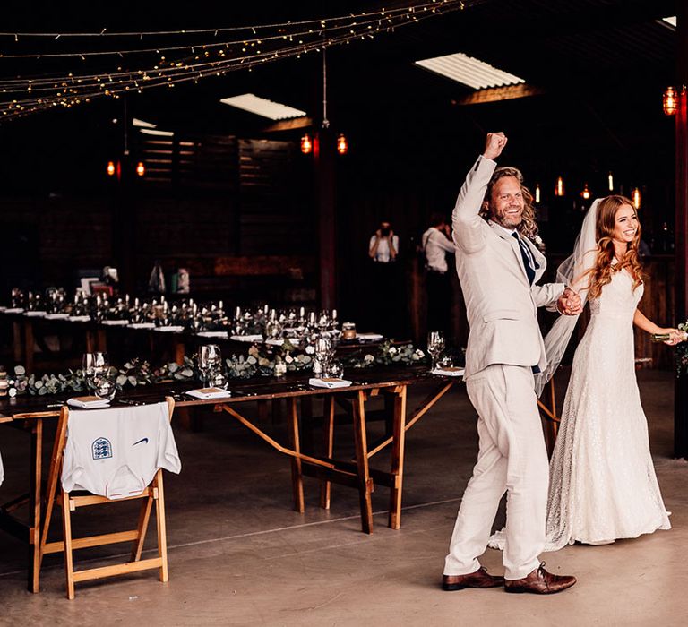 Bride and groom cheer as they make their entrance